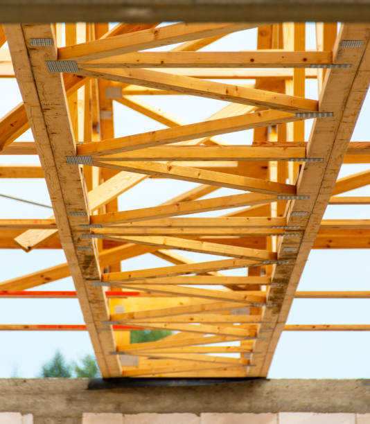 istock Wooden Truss Framework on New Construction Project Under Bright Sky with Modern Architectural Design Elements 2168276698