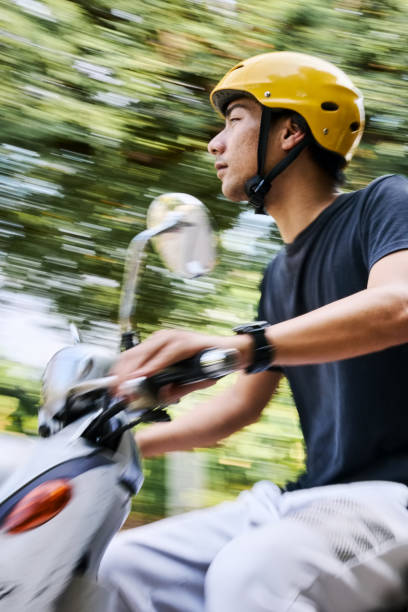 istock Young man riding on a moped scooter 2168277449