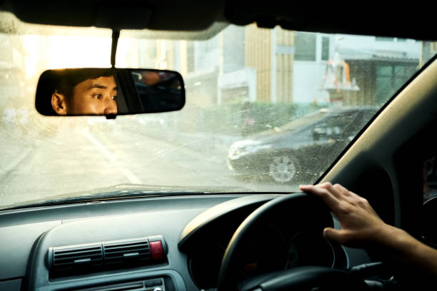 istock Driver seen in a rear view mirror of car 2168277567