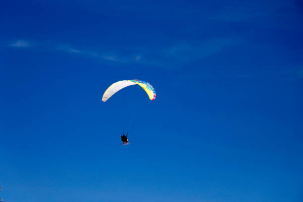 Paraglider soaring in the sky over the mountains. LionÂ´s Head and Table Mountain. Cape Town.  Camps Bay. Panorama.