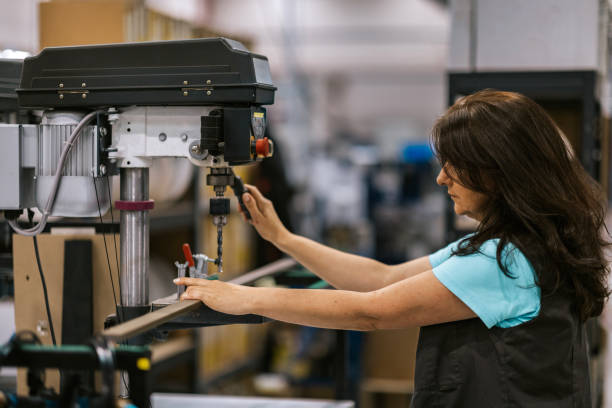 istock Woman operating a drill press in a textile production plant 2168282356
