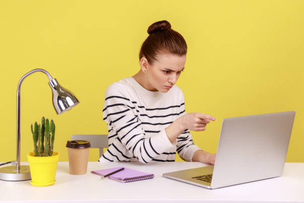 istock Angry woman office worker pointing to laptop screen, scolding and accusing talking on video call. 2168287729