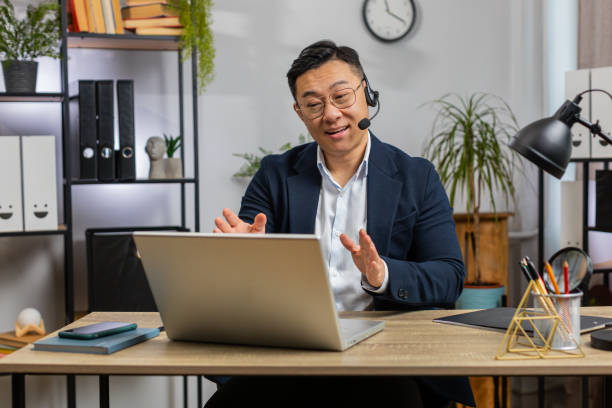 istock Businessman freelance worker call center support service operator helpline having talk with client 2168290330