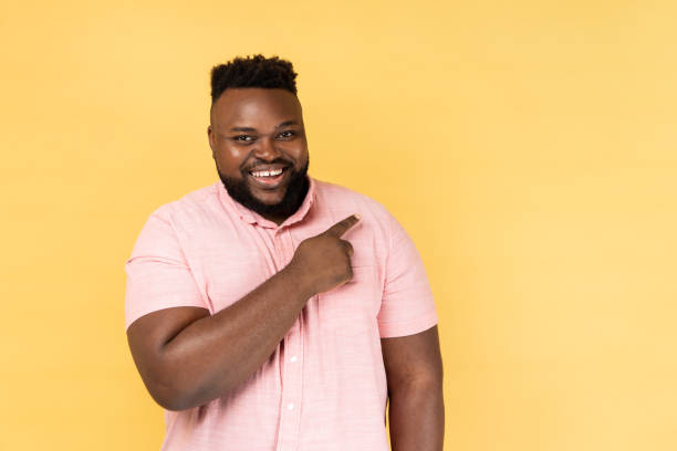 istock Man pointing aside, showing blank copy space for idea presentation, commercial text, smiling happily 2168291081