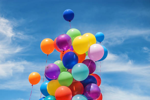 istock Colourful balloons isolated in a cloudy sky 2168293447