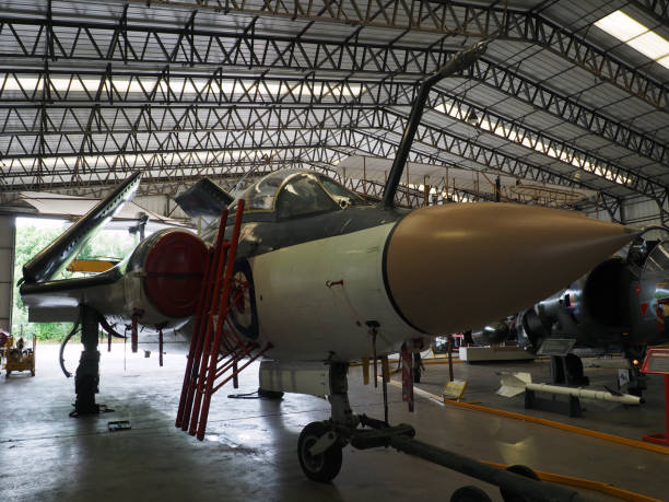 Sunlight streams through windows and reveals the iconic Mk Vc Supermarine Spitfire, seen here sitting in a traditional old aircraft hangar from WWII. Scale model photography.