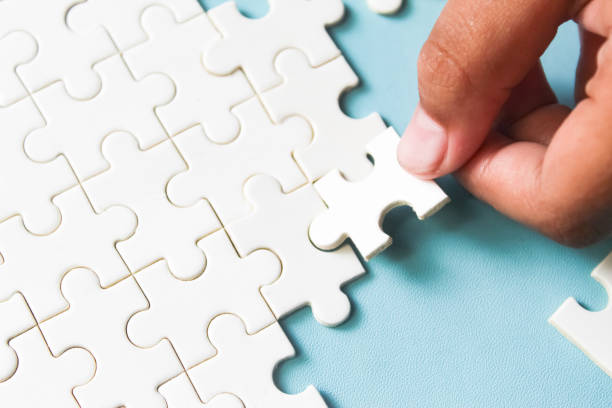 istock close up of hand connecting jigsaw puzzle 2168305428