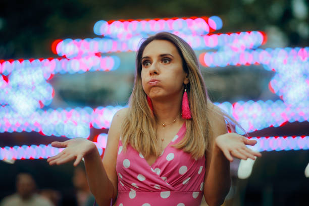 Surprised puzzled Woman Looking for Someone in an Amusement Park