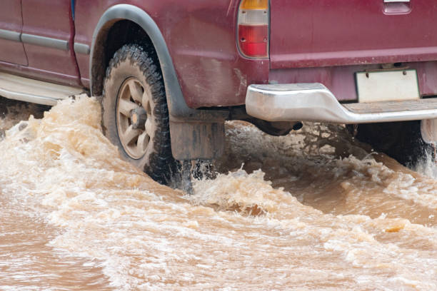 istock Car wheel in muddy rain and floodwater 2168309292