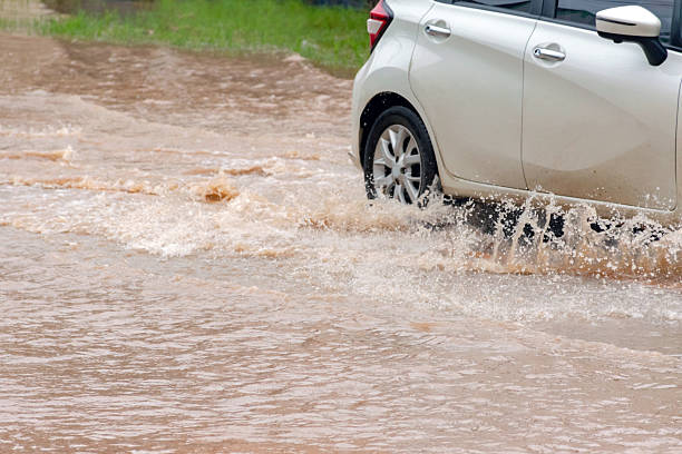istock Car wheel in muddy rain and floodwater 2168309295