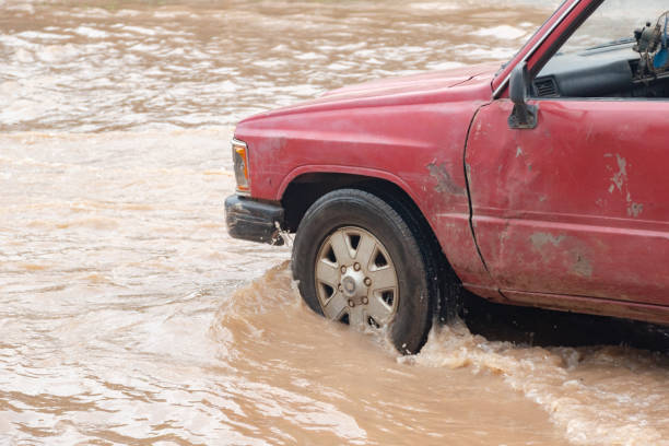 istock Car wheel in muddy rain and floodwater 2168309312