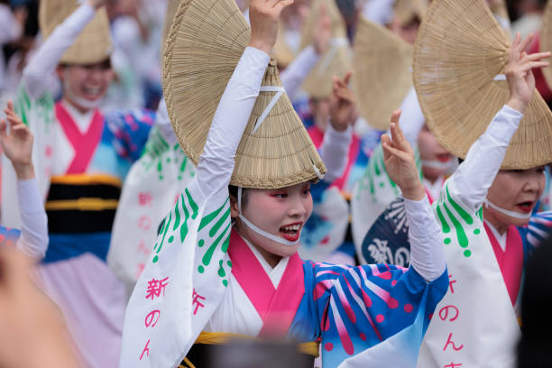 On August 24, 2024, in downtown Tokyo's Koenji district, many spectators watch as people enjoy dancing around in the sweltering heat at the two-day Awa Odori dance festival held along the main street and shopping arcades.