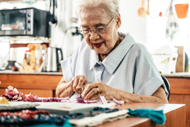 istock Senior woman cutting raw onions 2168326783