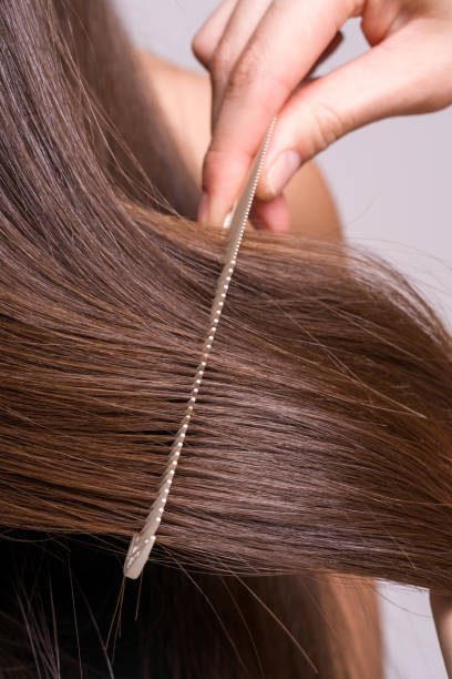 istock A woman's hair is being styled with a comb 2168327325