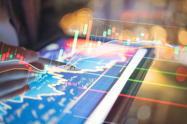 istock CGI overlay concept close-up of hands using a tablet to analyze stock market data, with a focusing to buy/sell signal with data analytic on financial charts and indicators. 2168333418