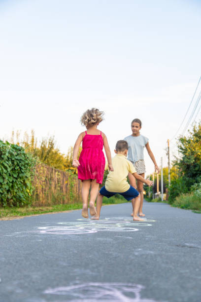 istock children play a classic game on the asphalt. Selective focus 2168334716