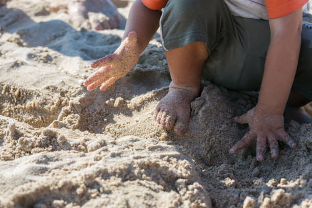 istock Toddler playing in the sand on a beach 2168337368
