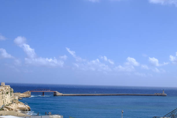Dock pier in quiet blue waters in Mediterranean Sea in Valletta, Malta