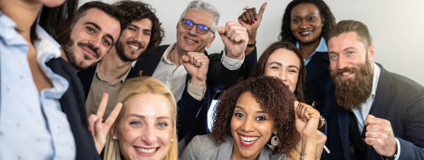 istock Horizontal banner or header with excited business team celebrating together with smiles and raised fists, capturing the energy of a successful collaboration. 2168338330