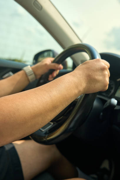istock close up, The young man is driving the car 2168338802