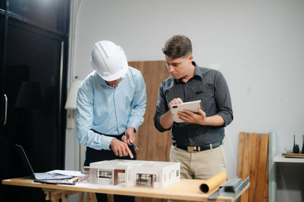 istock Contractor and architect looking at plan, tablet, laptop and talking about working on big project. 2168342960