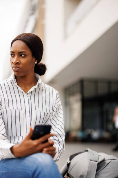 istock Young woman using phone in the city 2168346415