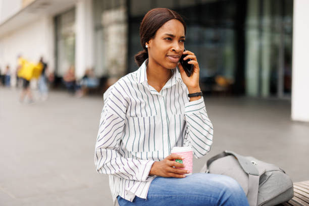 Young woman using phone in front of shopping mall