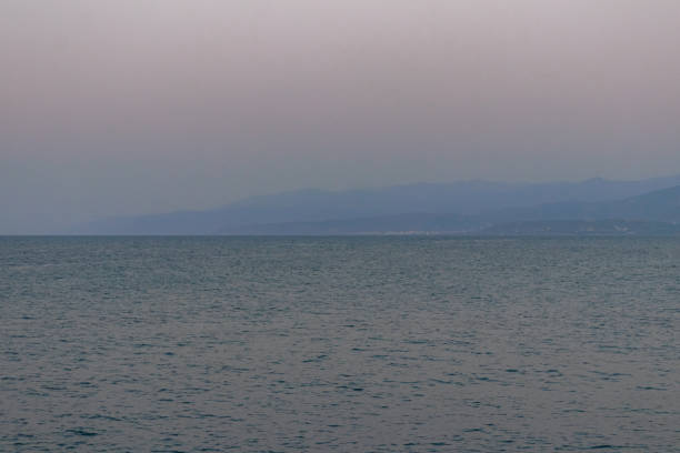 Hersonissos, Crete coastline viewing mountains over Sea of Crete at sunset