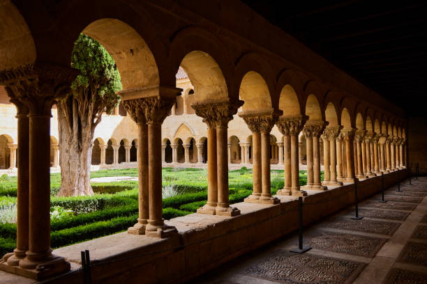 Silos (Burgos, Spain), August 14, 2024. Image of the Romanesque cloister composed of 2 sides with 16 arches and another 2 sides with 14 arches. The origin of the monastery is from the 10th century.