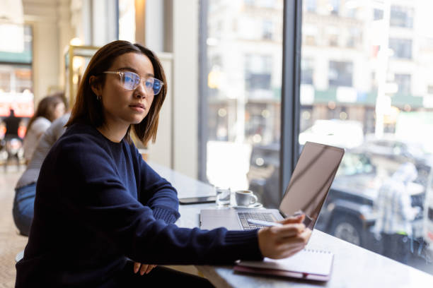 istock Young Professional Working by Window in Coffee Shop 2168350544