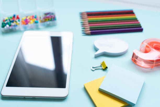 School and office supplies with digital tablet on blue background