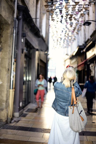 Independent female tourist exploring the town of Avignon in the Bouches du Rhone Department of Provence, France.