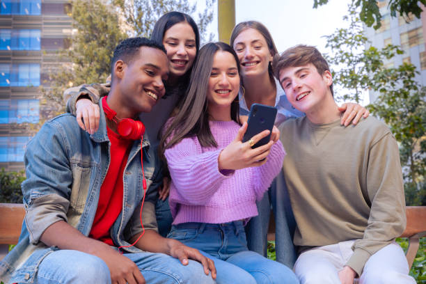 istock Students having fun with mobile phones creating content on social media. 2168354688