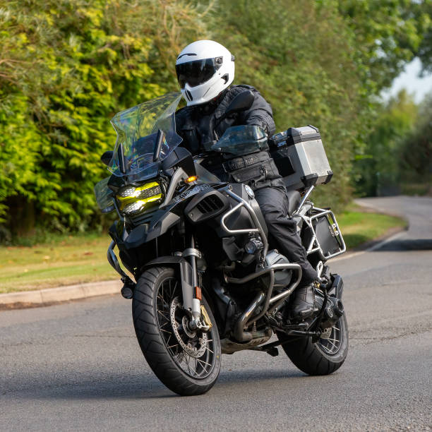 Whittlebury,Northants.,UK - Aug 25th 2024: Man riding a BMW R1200 motorcycle on a British country road.