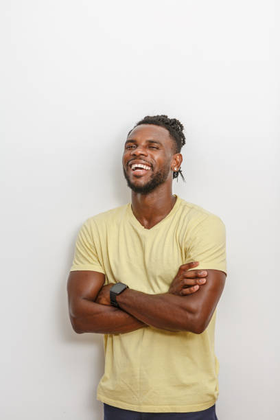 istock A smiling man with arms crossed poses against a plain white background 2168360819