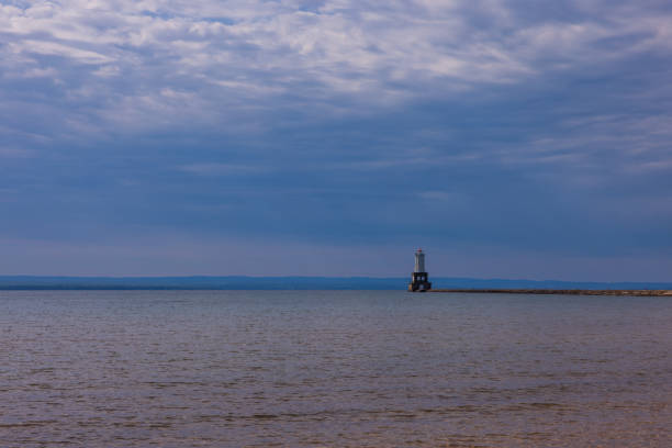 A lighthouse on the end of a breakwater on Lake Superior.
