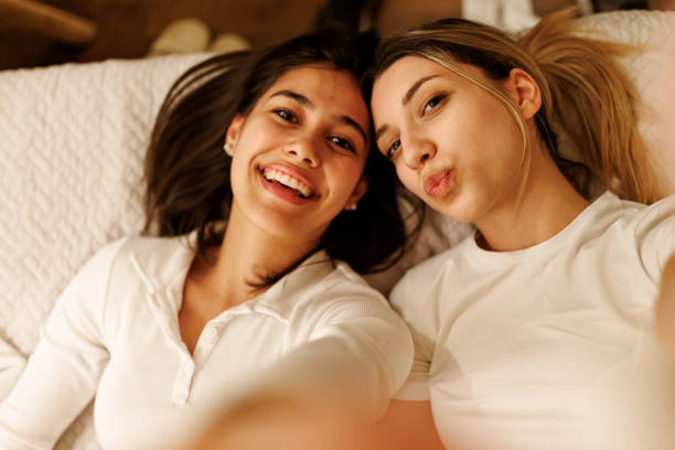 istock Female friends taking selfie at home 2168365392