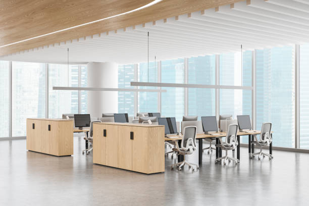 istock Stylish coworking interior with pc monitors in row, panoramic window 2168366788