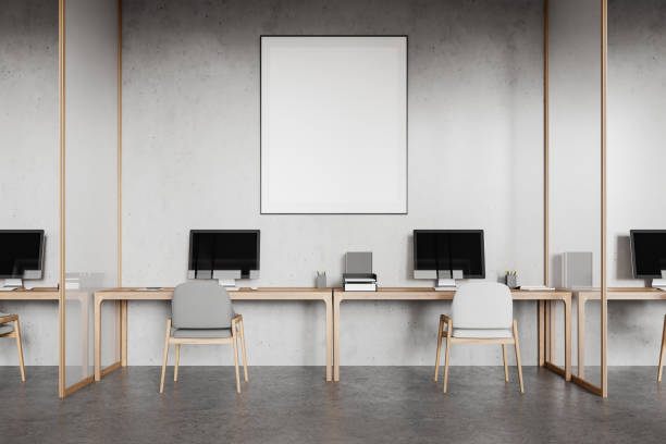 istock Stylish coworking interior with pc desktops on tables. Mockup frame 2168367758