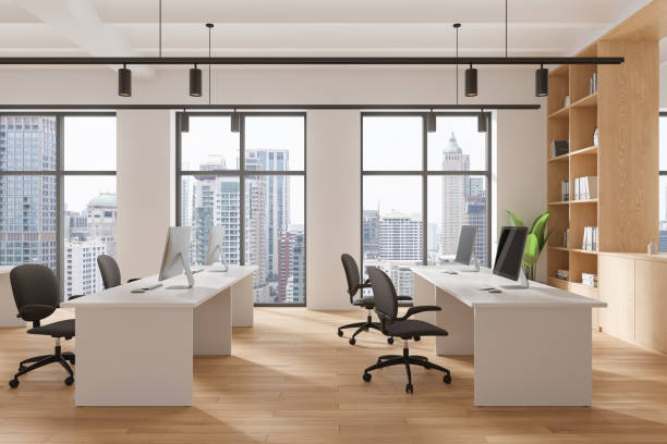 istock Stylish coworking interior with tables and pc desktop, panoramic window 2168367876