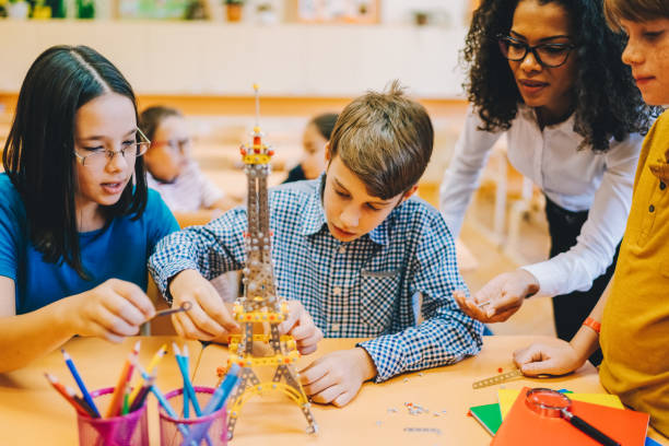 istock School children with mixed race teacher in class 2168369801