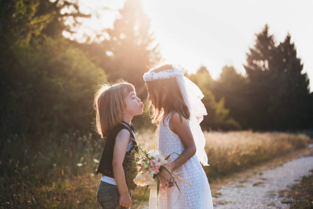 istock Little groom and bride share a kiss after vows 2168370501