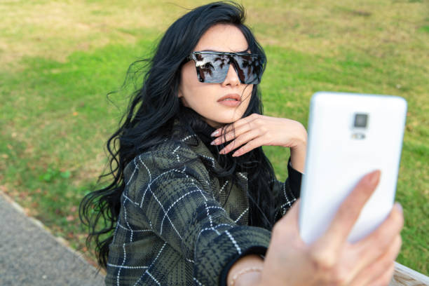 istock Young woman taking a selfie outdoors. 2168371646