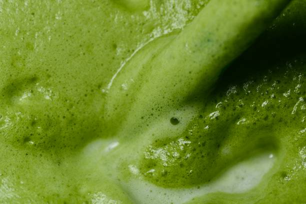 istock A close-up image of freshly made green tea, highlighting the smooth, frothy surface with visible air bubbles 2168372431