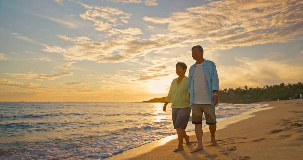 istock Asian elderly couple walk seaside 2168372801