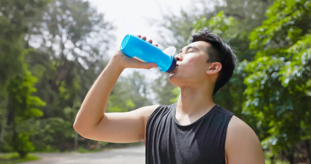 istock asian male drink water park 2168373697