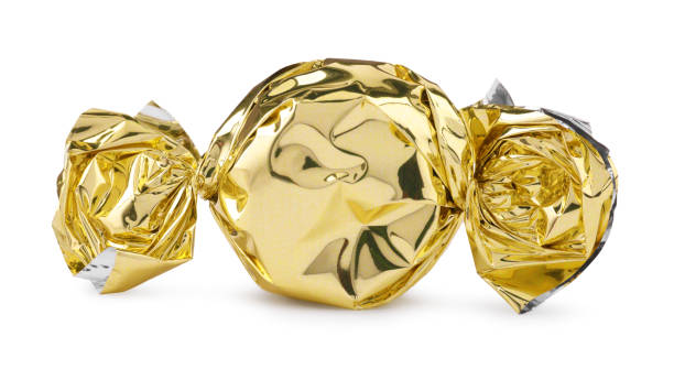 istock Candy in golden wrapper isolated on white 2168375762
