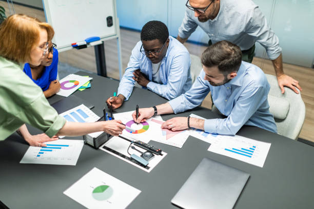 istock Business team working on new project using laptops, white board, diagrams 2168380750