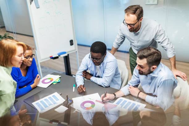 istock Business team working on new project using laptops, white board, diagrams 2168381076