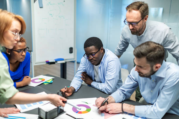 istock Business team working on new project using laptops, white board, diagrams 2168381441